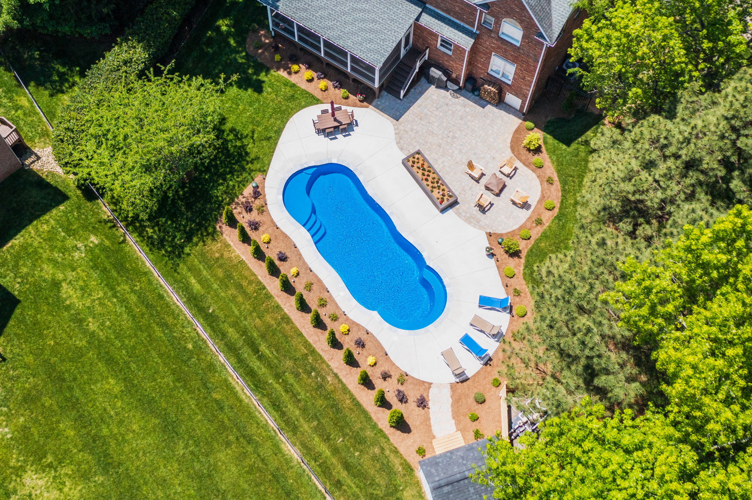 River Pools C40 in Maya Shimmer with brushed concrete and natural stone coping 4